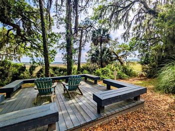 Marsh Cove Apartments in Savannah Georgia photo of a large wooden deck with benches and a table
